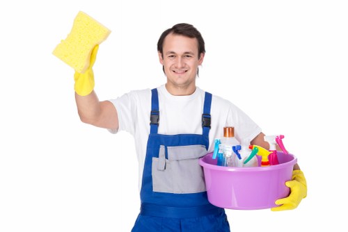 Office cleaner in Kingston preparing a clean and tidy workspace for staff